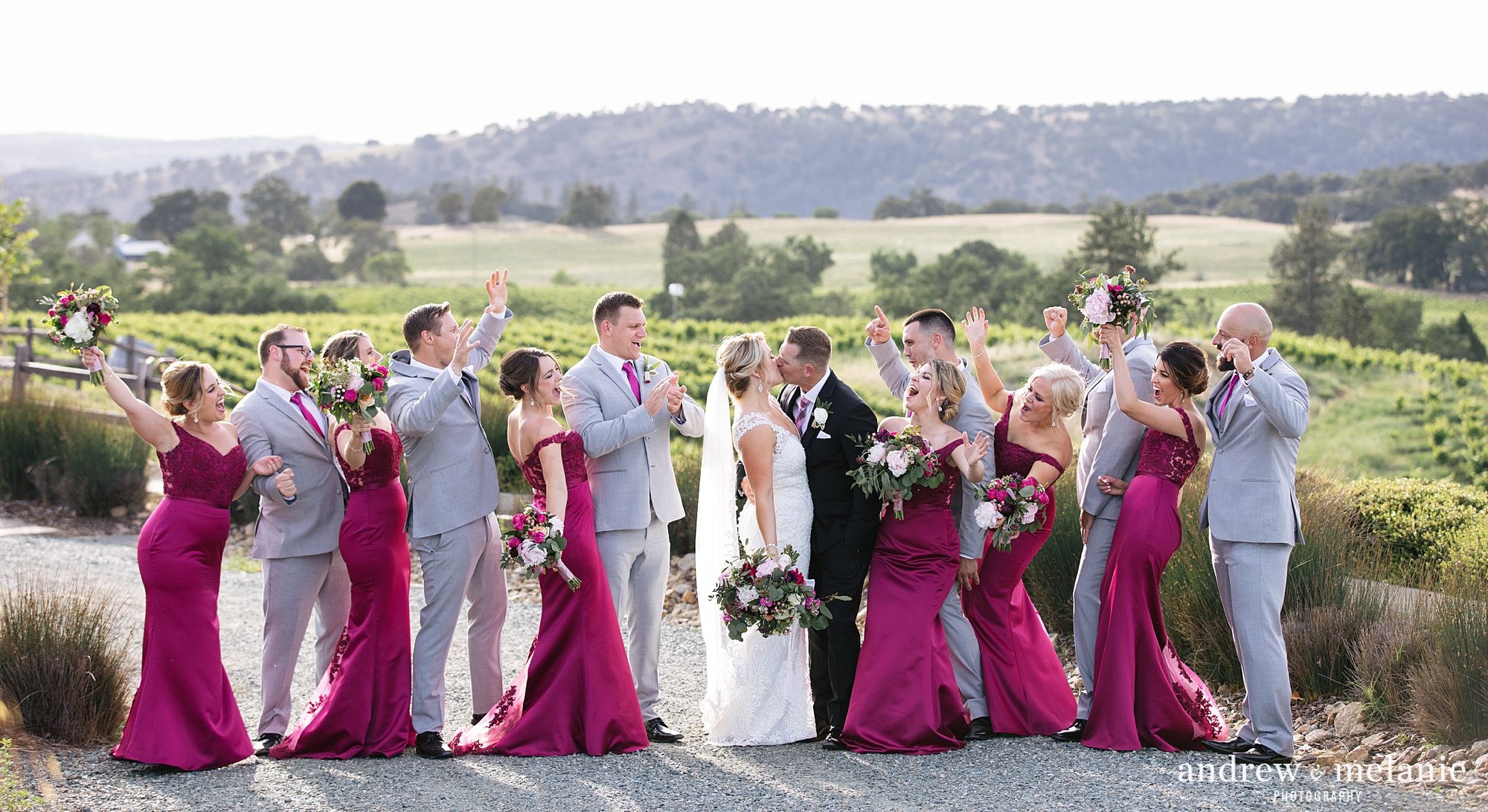 bridal party wedding photo at Helwig Winery in Jackson, CA. magenta dresses and grey suits